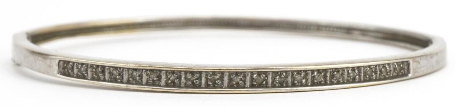 9ct white gold and diamond hinged bangle housed in an Arcade Jewellers Bournemouth box, 6cm wide,