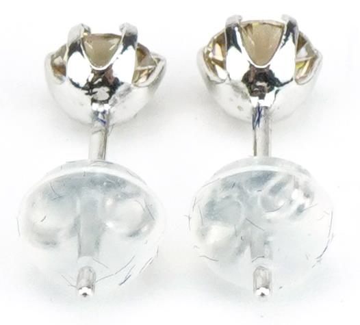 Pair of platinum round brilliant cut diamond solitaire stud earrings, total diamond weight - Image 2 of 3