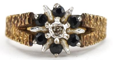 18ct gold diamond and sapphire starburst ring with bark design shoulders, size N/O, 4.7g