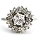 Unmarked white gold diamond three tier cluster ring, the central diamond approximately 0.65 carat,