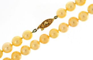 Single string cultured pearl necklace with 9ct gold clasp, housed in a Walker and Hall box, 44cm