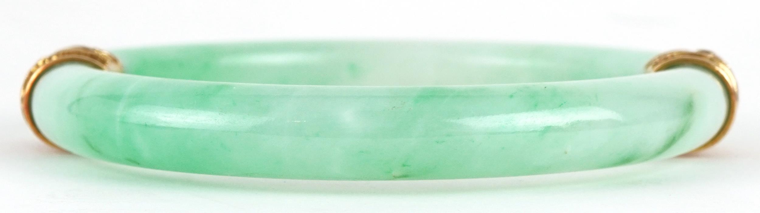 Chinese green jade bangle with unmarked gold mounts decorated in relief with dragons, 9.5cm in - Image 2 of 5