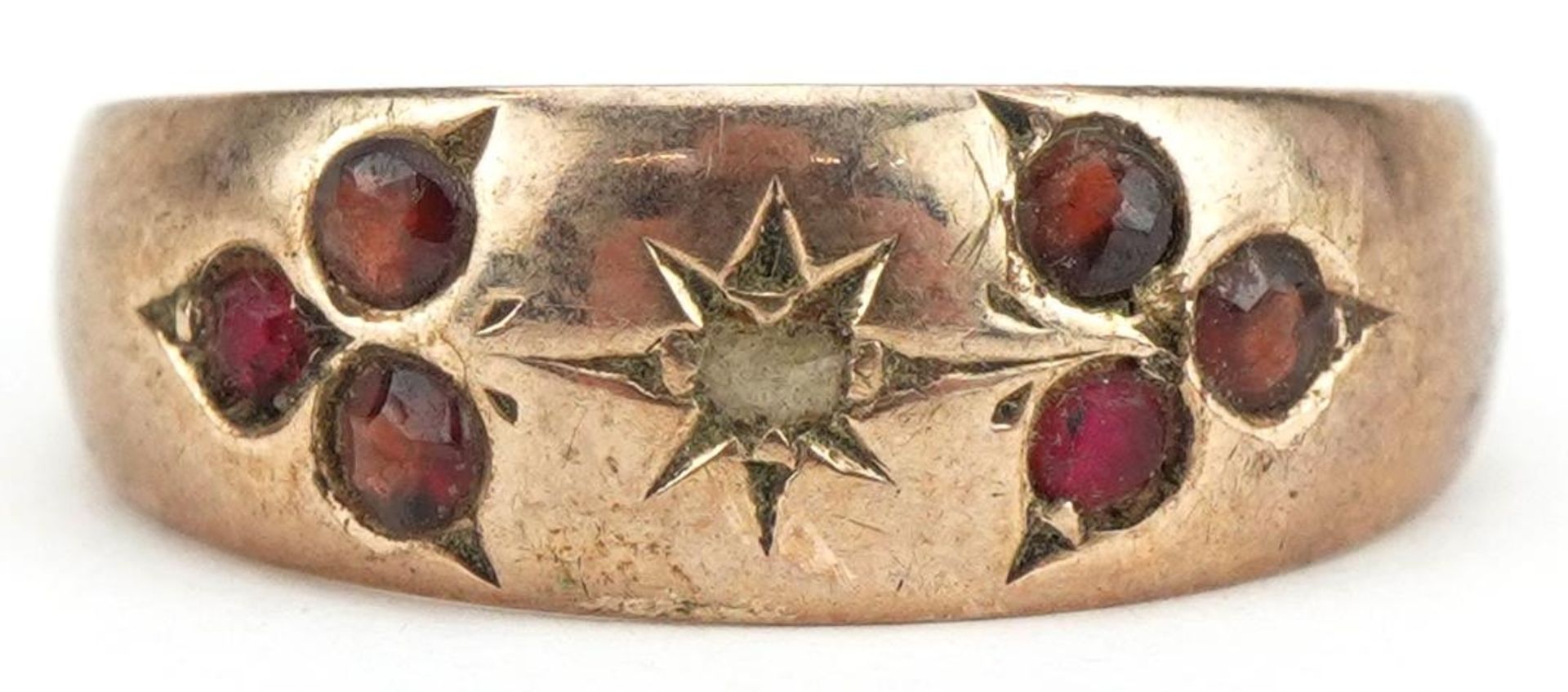 9ct rose gold garnet and diamond seven stone ring, size N, 1.9g