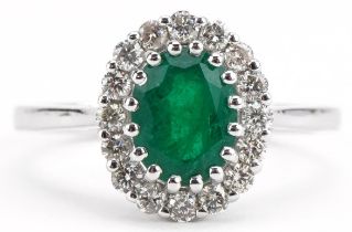 18ct white gold oval emerald and diamond cluster ring, total diamond weight approximately 0.37