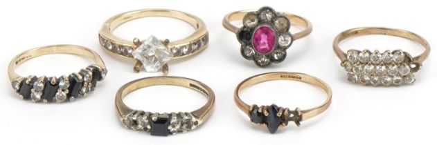 Six 9ct gold rings set with assorted stones including sapphires, one with silver setting, total