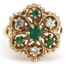 Gold emerald and diamond flower head ring with pierced setting indistinct marks, tests as 14ct gold,