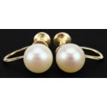 Pair of 14ct gold Mikimoto pearl earrings with screw backs, 1.4cm in length, 2.6g