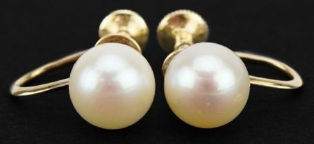 Pair of 14ct gold Mikimoto pearl earrings with screw backs, 1.4cm in length, 2.6g