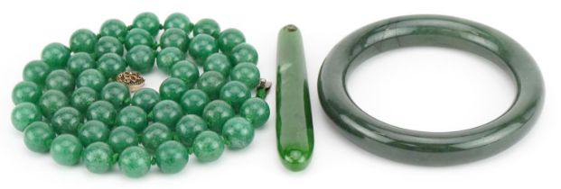 Chinese green jade jewellery comprising bead necklace with silver gilt clasp, bangle and pendant,