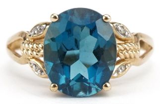 9ct gold blue topaz solitaire ring with diamond set shoulders, the topaz approximately 11.10mm x 9.