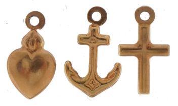Three unmarked gold Faith, Hope and Charity charms, tests as 9ct gold, 1.4cm high, 0.9g