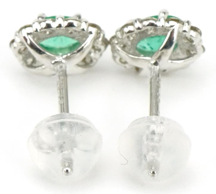 Pair of 18ct white gold oval emerald and diamond cluster stud earrings, total diamond weight - Image 2 of 3
