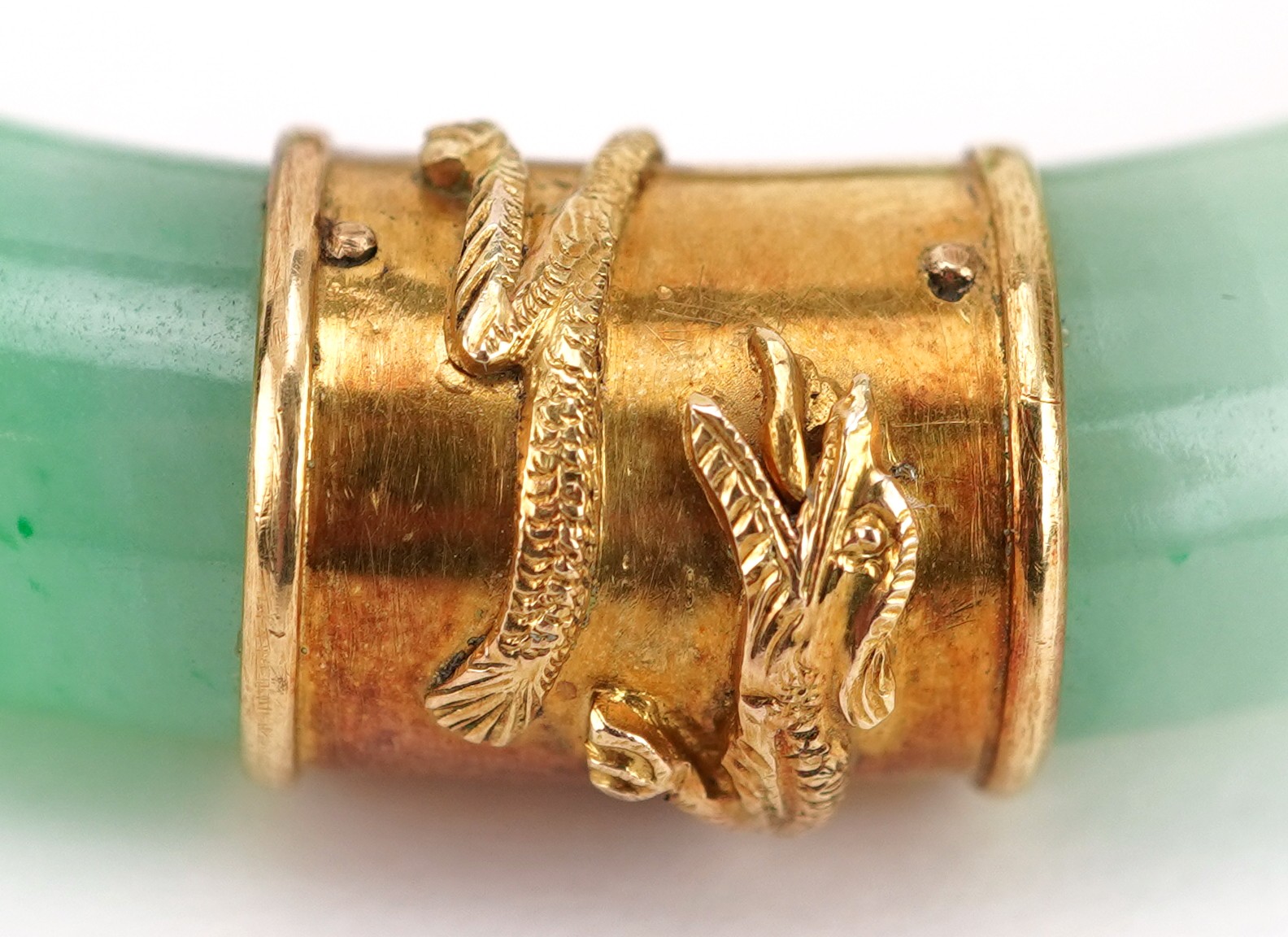 Chinese green jade bangle with unmarked gold mounts decorated in relief with dragons, 9.5cm in - Image 5 of 5
