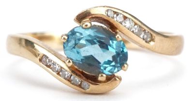 9ct gold blue topaz and diamond crossover ring, size O, 2.6g