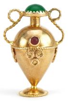 Unmarked gold twin handled urn charm set with green and red cabochons, tests as 9ct gold, 3.1cm