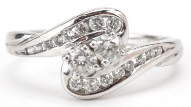 9ct white gold cubic zirconia crossover ring, size Q/R, 3.3g