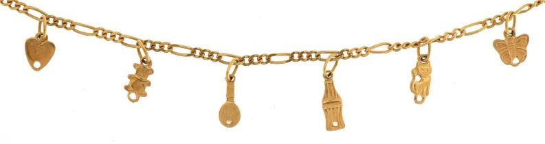 18ct gold Figaro link charm bracelet with six gold charms, 18cm in length, 3.5g