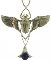 Egyptian Revival silver scarab beetle pendant set with a cabochon lapis lazuli on a silver necklace,