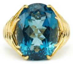 Large 9ct gold blue topaz solitaire ring with naturalistic shoulders, the topaz approximately 18.0mm