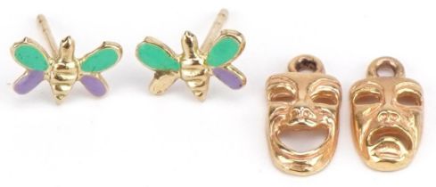 Two 9ct gold theatrical masks charms and a pair of 9ct gold and enamel butterfly stud earrings,