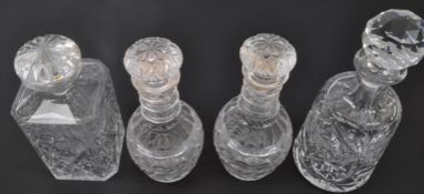 COLLECTION OF FOUR CUT GLASS DECANTERS WITH STOPPERS