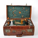 AN EDWARDIAN TRAVEL TRUNK WITH AN ASSORTMENT OF SILVER ITEMS