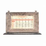 AN ART DECO SILVER AND WOOD DESK CALENDAR