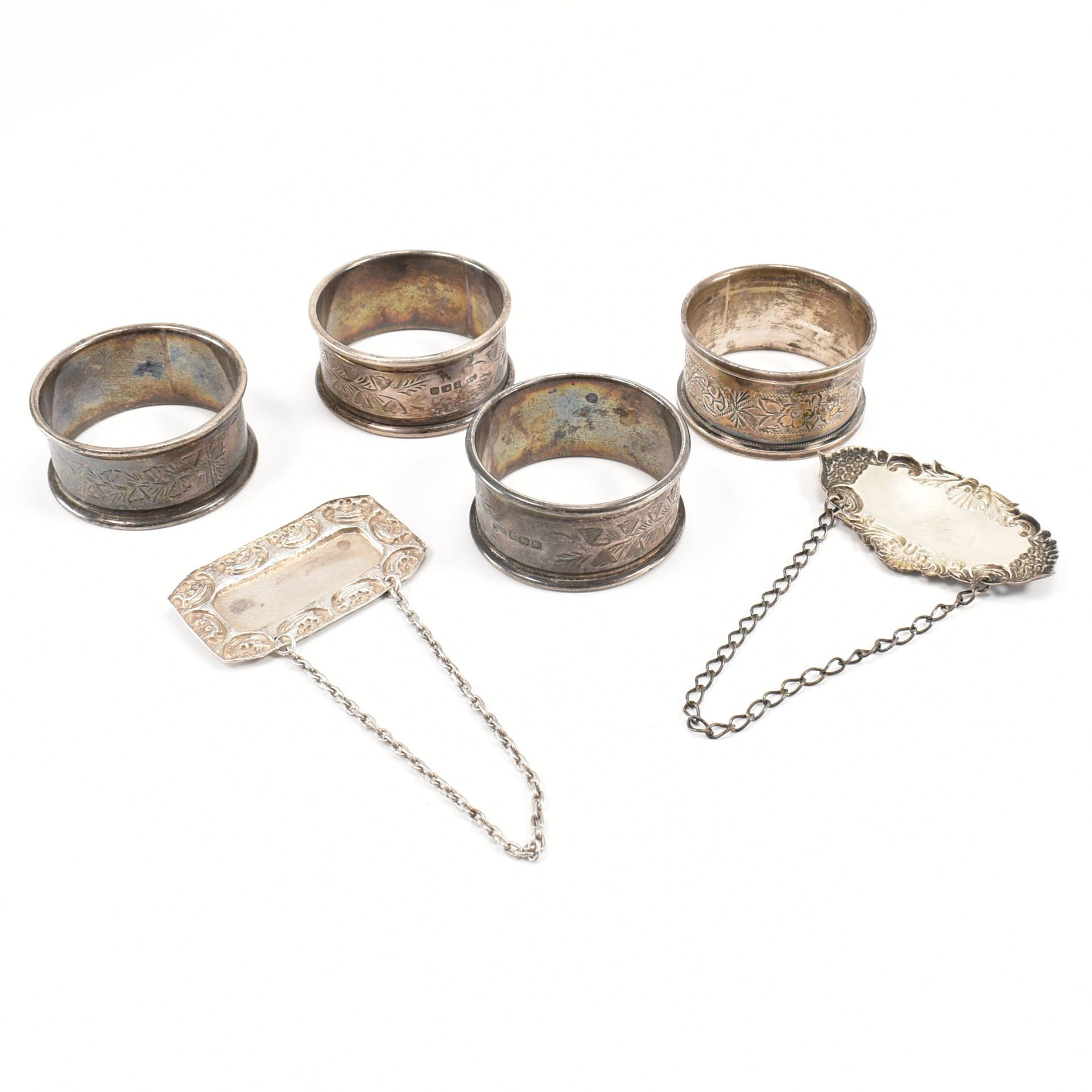 FOUR EDWARDIAN SILVER NAPKIN RINGS & 2 DECANTER LABELS - Image 2 of 4