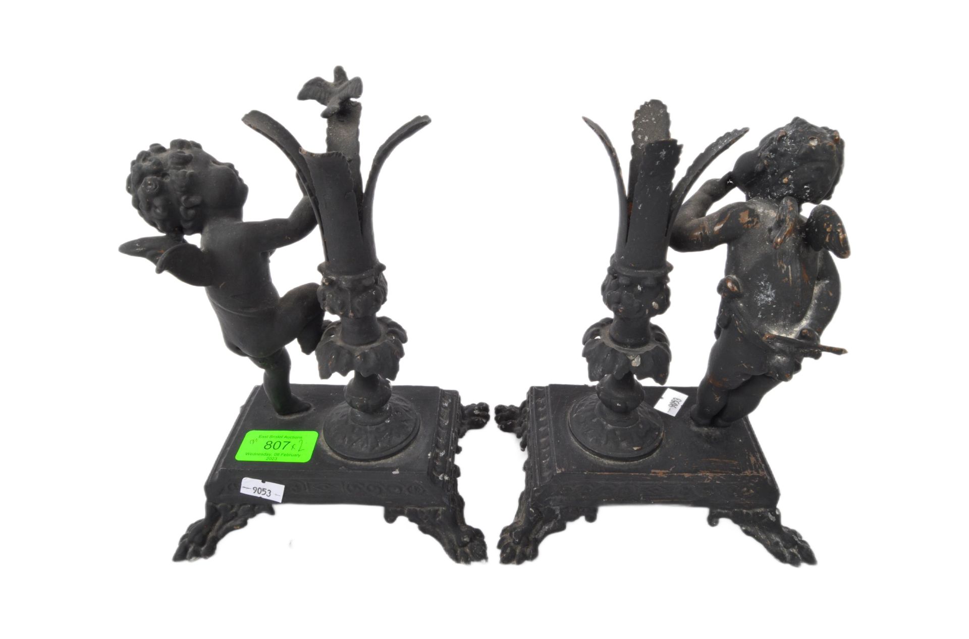 PAIR OF 20TH CENTURY CAST IRON EBONISED CHERUB CANDLE HOLDERS