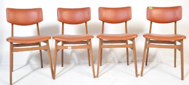 A matching set of four retro mid 20th Century beech framed dining chairs each with faux burgundy