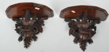 PAIR OF 20TH CENTURY CARVED BLACK FOREST WALL SCONCES