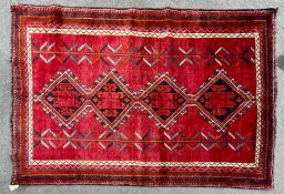 A 20th century South West Persian Islamic Lori floor carpet rug having a central red panel with