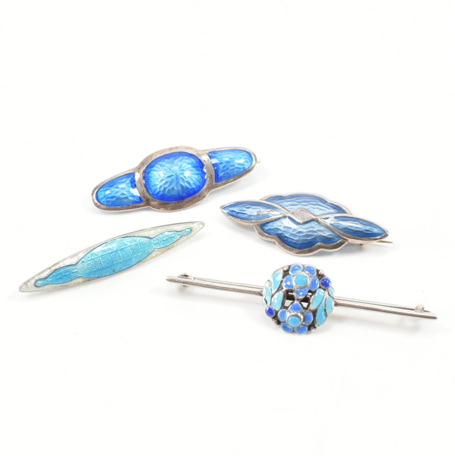 FOUR EARLY 20TH CENTURY SILVER & ENAMEL BROOCH PINS