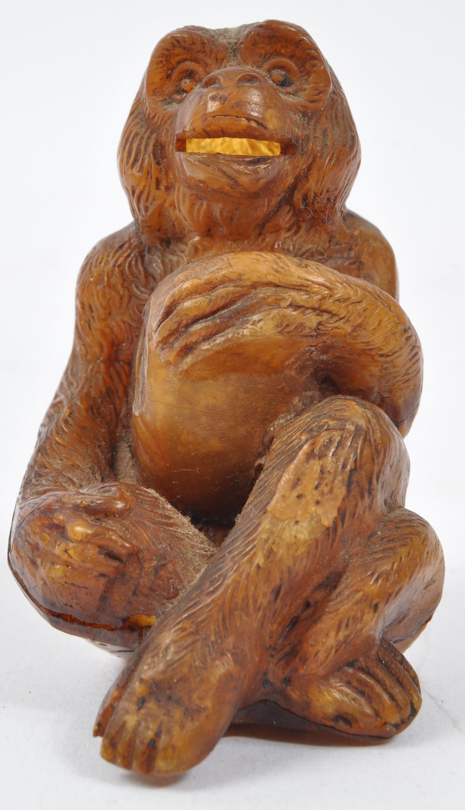 20TH CENTURY COMPOSITE AMBER MONKEY FIGURE - Image 2 of 5