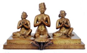 THREE BRONZE HINDU FIGURES IN PRAYER MOUNTED ON BRONZE PANEL