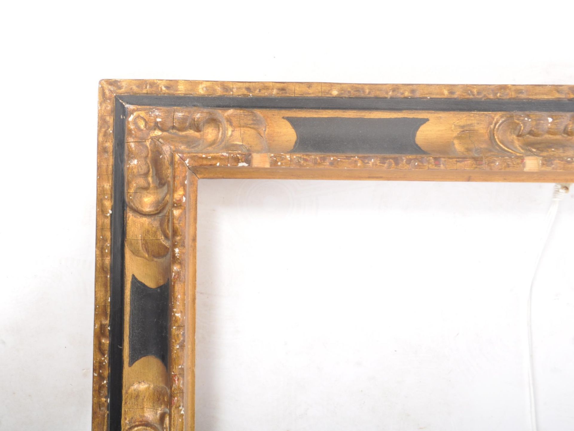 An early 20th century black and gilt wooden picture frame, with moulded edges and foliate scrolled - Image 2 of 6