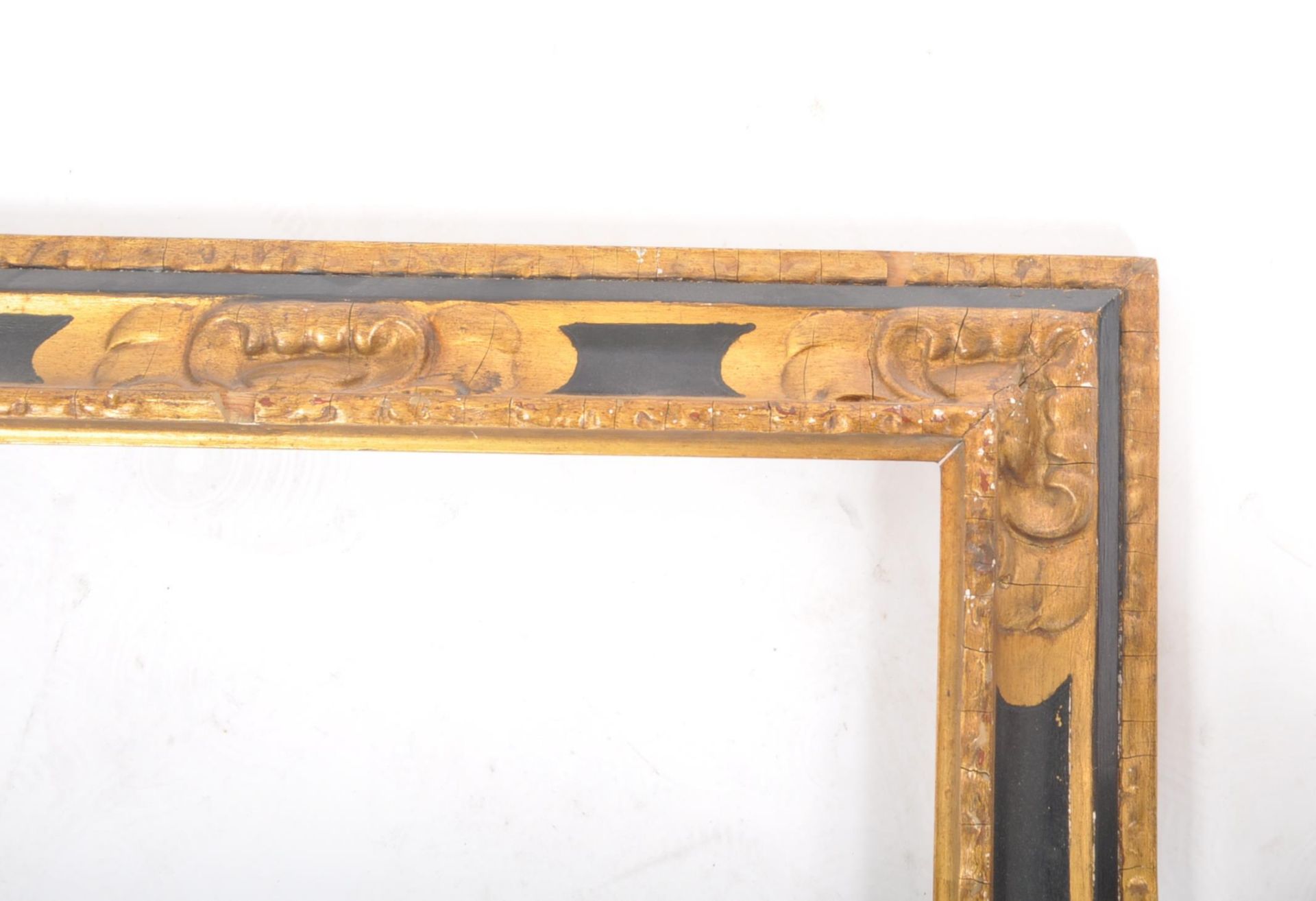 An early 20th century black and gilt wooden picture frame, with moulded edges and foliate scrolled - Image 4 of 6