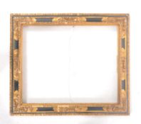 An early 20th century black and gilt wooden picture frame, with moulded edges and foliate scrolled