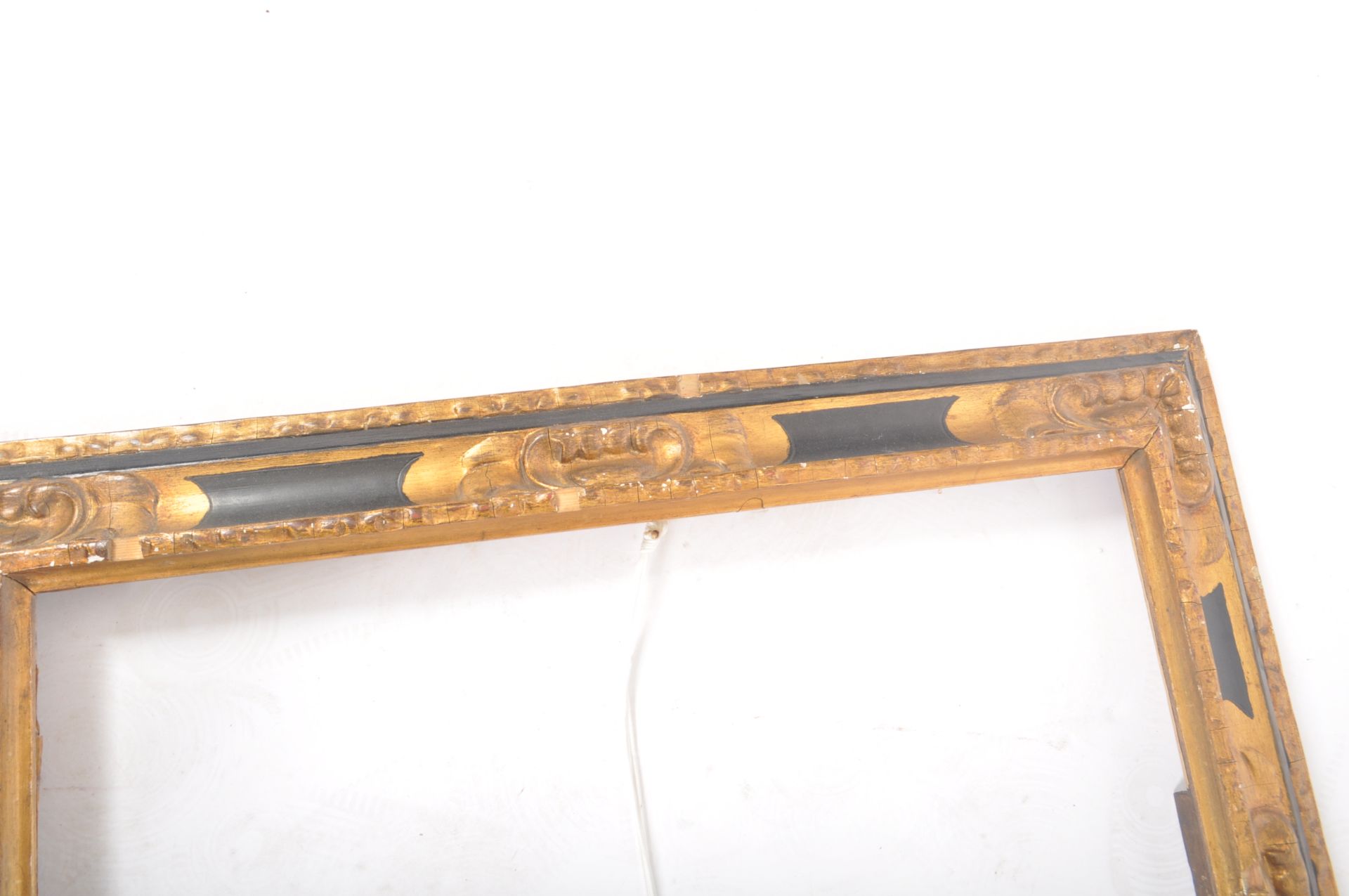 An early 20th century black and gilt wooden picture frame, with moulded edges and foliate scrolled - Image 3 of 6