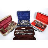 FOUR VINTAGE CLARINETS IN FITTED HARD CASES