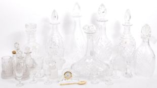 A LARGE COLLECTION OF CUT GLASS DECANTERS AND OTHER ITEMS