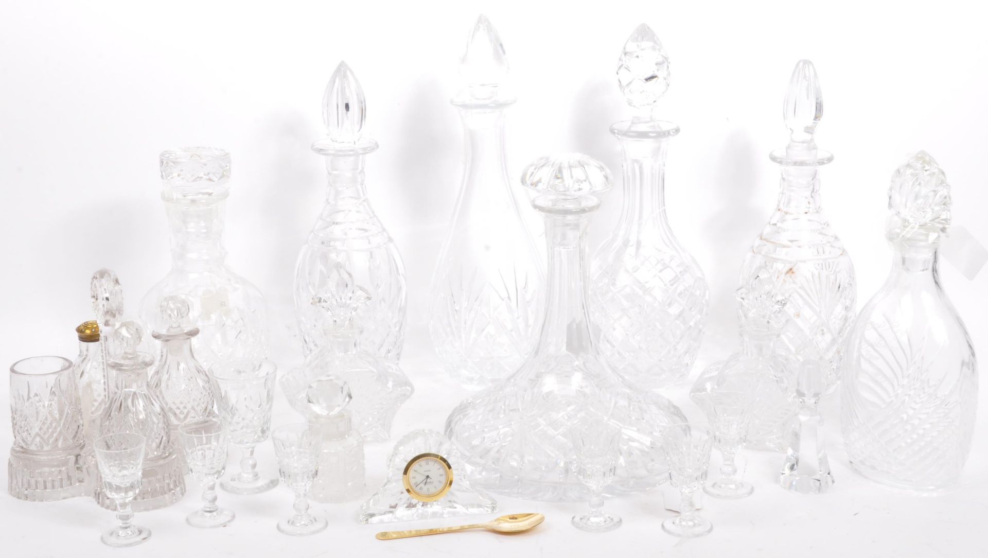 A LARGE COLLECTION OF CUT GLASS DECANTERS AND OTHER ITEMS