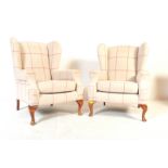PAIR OF 20TH CENTURY UPHOLSTERED WING BACK ARMCHAIRS