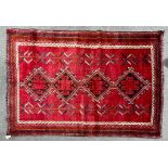 A 20th century South West Persian Islamic Lori floor carpet rug having a central red panel with