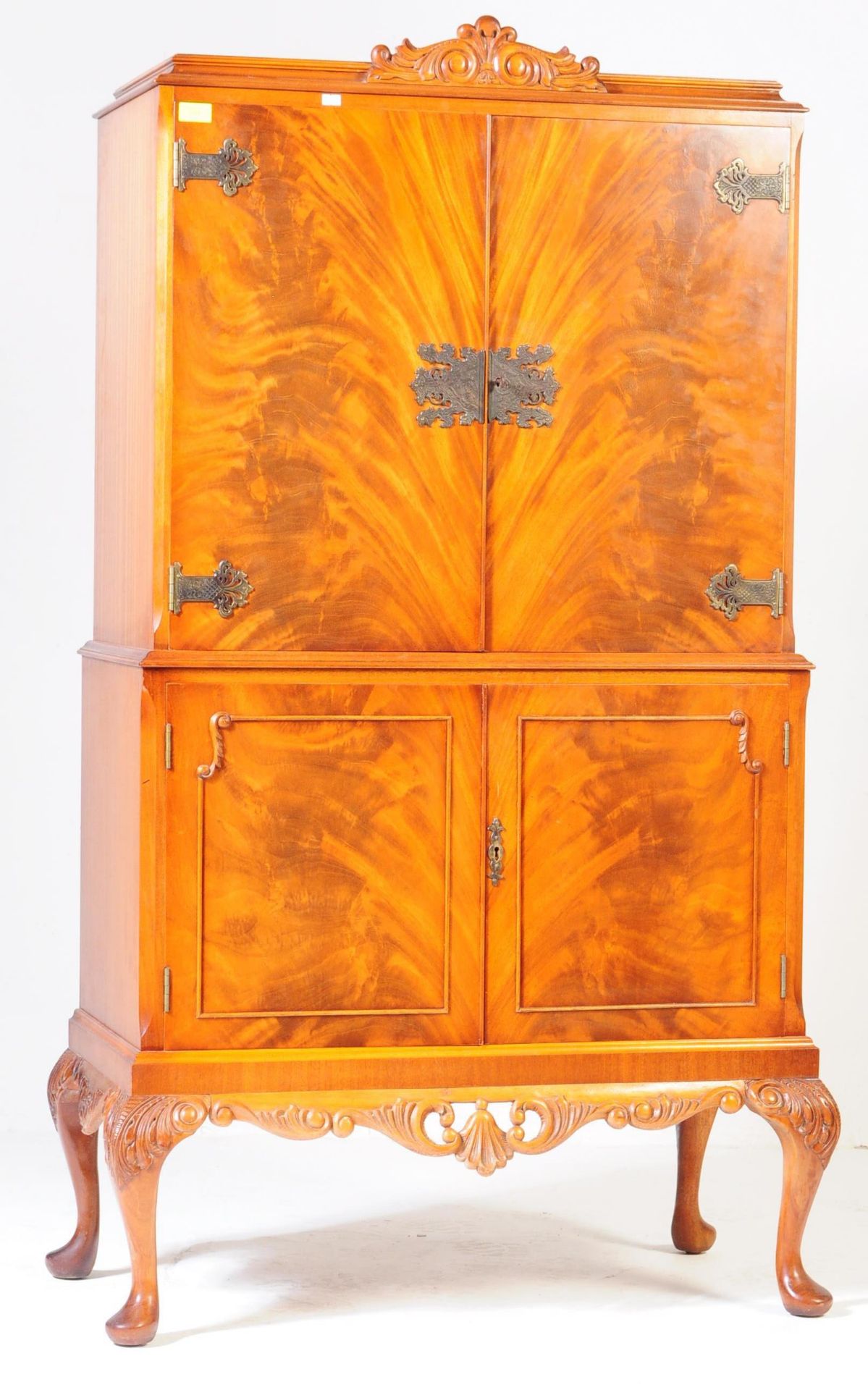 A 20TH CENTURY WALNUT DRINKS CABINET WITH SCROLL MOTIFS