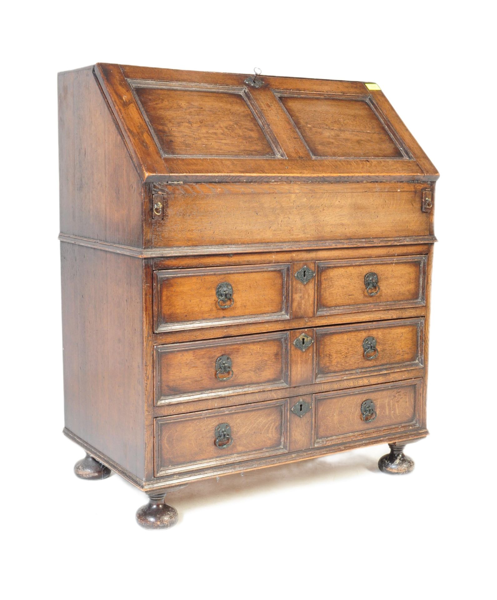 AN EARLY 20TH CENTURY JACOBEAN REVIVAL OAK WRITING BUREAU