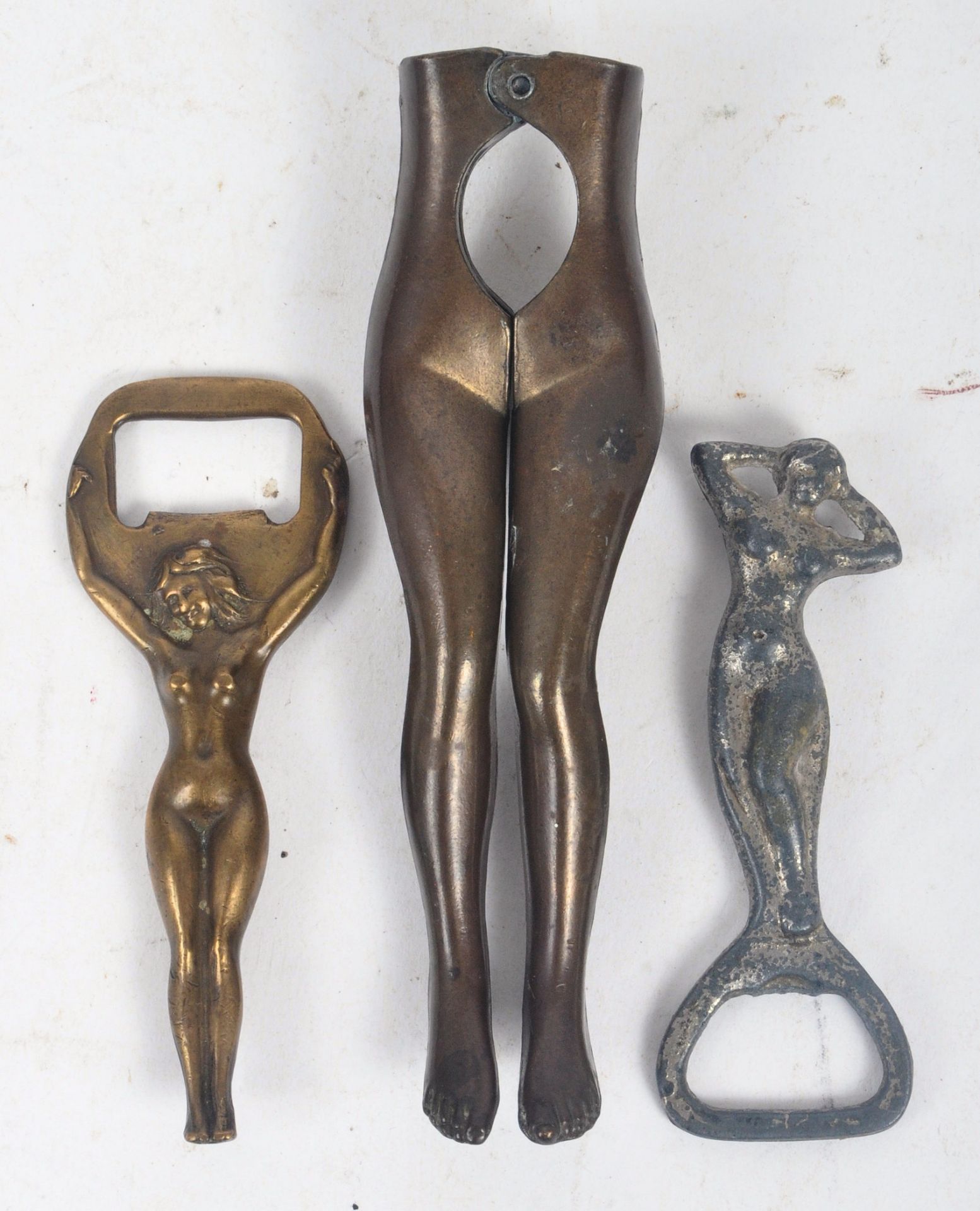 THREE EARLY 20TH CENTURY EROTICA NOVELTY BOTTLE OPENERS