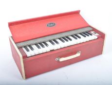 DULCET - A CIRCA 1950S/1960S PORTABLE PIANO IN RED BOX