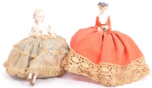TWO EARLY 20TH CENTURY PORCELAIN DOLL PIN CUSHIONS