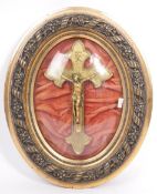 20TH CENTURY CATHOLIC GILT METAL CRUCIFIX IN DOMED FRAME